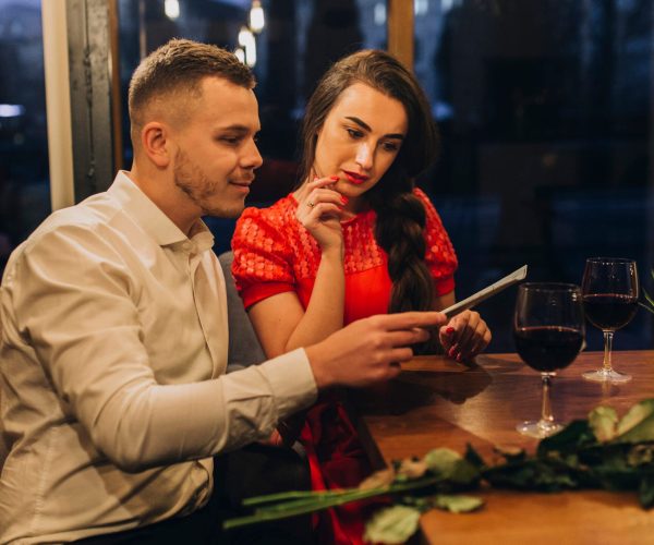 people-date-restaurant-reading-menu